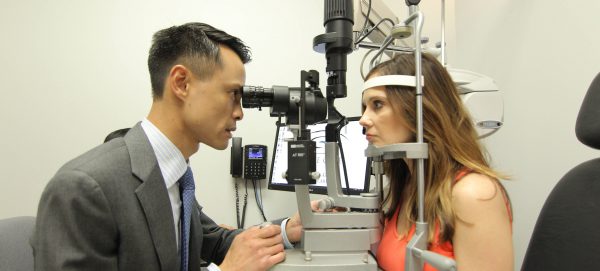 Dr. Gee examines the eyes of one of his patients at his private practice in Houston